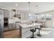 This kitchen features stainless steel appliances, gray cabinets, an island with a sink, and hardwood floors at 2131 Landsburg Way, Lawrenceville, GA 30043