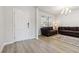 Bright living room with hardwood floors, a white front door, and plush sofas, perfect for relaxation at 2131 Landsburg Way, Lawrenceville, GA 30043