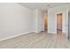 Open room featuring neutral walls, wood flooring and multiple doorways at 2131 Landsburg Way, Lawrenceville, GA 30043