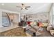 Open-concept living room with hardwood floors, stairs, comfortable seating, and a view into the modern kitchen at 2131 Landsburg Way, Lawrenceville, GA 30043