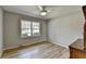 Bright bedroom with wood-look floors and a window at 3081 Frankie Ln, Duluth, GA 30096