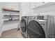 Laundry room with washer, dryer, and shelving at 4266 Cabretta Se Dr, Smyrna, GA 30080