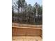 Spacious backyard with a wood fence surrounded by many trees at 1346 Lucan Ln # Wc227, Lawrenceville, GA 30043