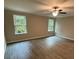 Spacious bedroom features hardwood floors, natural light, and a ceiling fan at 1346 Lucan Ln # Wc227, Lawrenceville, GA 30043