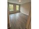 This bedroom offers modern plank flooring and natural light from the pair of windows at 1346 Lucan Ln # Wc227, Lawrenceville, GA 30043