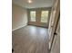 This bedroom offers modern plank flooring and natural light from the pair of windows at 1346 Lucan Ln # Wc227, Lawrenceville, GA 30043