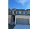 Brick front exterior of charming townhome with 2-car garage at 1346 Lucan Ln # Wc227, Lawrenceville, GA 30043
