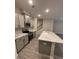 Open kitchen featuring gray cabinets, stainless appliances, granite counters, and a center island with breakfast bar at 1346 Lucan Ln # Wc227, Lawrenceville, GA 30043