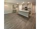 Open kitchen features stainless appliances, shaker cabinets, granite counters, and a central island at 1346 Lucan Ln # Wc227, Lawrenceville, GA 30043