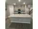 Open kitchen featuring gray cabinets, stainless appliances, granite counters, and a center island with breakfast bar at 1346 Lucan Ln # Wc227, Lawrenceville, GA 30043
