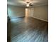 Living room featuring neutral walls, crown moulding, and hardwood floors at 1346 Lucan Ln # Wc227, Lawrenceville, GA 30043