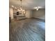 Open-concept living room with hardwood floors and a modern kitchen featuring a large island at 1346 Lucan Ln # Wc227, Lawrenceville, GA 30043