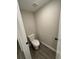 Powder room featuring a toilet and hardwood floors at 1346 Lucan Ln # Wc227, Lawrenceville, GA 30043