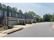 Exterior view of new townhomes boasting attached garages along a pristine street at 1346 Lucan Ln # Wc227, Lawrenceville, GA 30043
