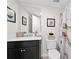 Bathroom featuring a dark vanity, framed mirror, framed prints and neutral shower curtain at 1366 Lucan Ln # Wc225, Lawrenceville, GA 30043
