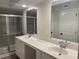 Bathroom with double vanity, elegant countertops and a glass enclosed shower at 1366 Lucan Ln # Wc225, Lawrenceville, GA 30043