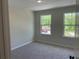 Bedroom with carpet, neutral walls and two windows allowing for natural light at 1366 Lucan Ln # Wc225, Lawrenceville, GA 30043