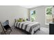 Bright bedroom featuring neutral walls, carpeted floors, and windows for natural light at 1366 Lucan Ln # Wc225, Lawrenceville, GA 30043