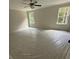 Bright bedroom featuring a ceiling fan and two windows offering natural light at 1366 Lucan Ln # Wc225, Lawrenceville, GA 30043