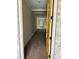 Entryway has hardwood floors and a yellow door leading to an open floor plan at 1366 Lucan Ln # Wc225, Lawrenceville, GA 30043
