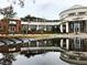 Stunning exterior reflecting in a puddle on a cloudy day with beautiful community landscaping at 1366 Lucan Ln # Wc225, Lawrenceville, GA 30043