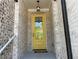 Charming, covered entry features a yellow front door and a hanging lantern at 1366 Lucan Ln # Wc225, Lawrenceville, GA 30043
