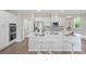Bright and modern kitchen with white cabinets, stainless steel appliances, and a quartz countertop island at 1366 Lucan Ln # Wc225, Lawrenceville, GA 30043