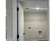 Small laundry room with washer dryer hookups and wire shelving at 1366 Lucan Ln # Wc225, Lawrenceville, GA 30043