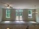 Spacious living room with hardwood floors and natural light from the white-framed windows and sliding glass doors at 1366 Lucan Ln # Wc225, Lawrenceville, GA 30043