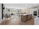 Open concept living space with modern kitchen, living and dining area with wood floors at 1366 Lucan Ln # Wc225, Lawrenceville, GA 30043