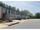 New townhome construction with tree-lined streets and individual two-car garages at 1366 Lucan Ln # Wc225, Lawrenceville, GA 30043