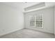 Simple bedroom with carpeted floors and a large window at 50 Biscayne Dr # 2109, Atlanta, GA 30309