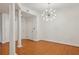 Hardwood floor dining room with chandelier and view into kitchen at 50 Biscayne Dr # 2109, Atlanta, GA 30309