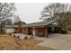 Brick house back exterior with a covered carport, patio area, and level yard at 3421 Fawn Trl, Marietta, GA 30066
