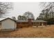 View of the backyard with a brick patio and mature trees at 3421 Fawn Trl, Marietta, GA 30066