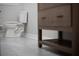Modern toilet, sink, and vanity with wooden shelves at 3421 Fawn Trl, Marietta, GA 30066