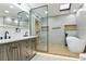 Bright bathroom showcasing a double sink vanity, glass shower, soaking tub, and a skylight for natural light at 3421 Fawn Trl, Marietta, GA 30066