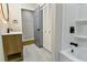 Bathroom showcasing modern fixtures, including an illuminated mirror, wood-look vanity, and white tile floors at 3421 Fawn Trl, Marietta, GA 30066