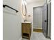 Bathroom featuring a wood-look vanity, an illuminated mirror, white tile floors, and modern fixtures at 3421 Fawn Trl, Marietta, GA 30066