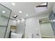 Bright bathroom featuring a modern soaking tub under skylights, a toilet and open doorway at 3421 Fawn Trl, Marietta, GA 30066