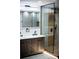 Beautiful bathroom featuring a vanity with double sinks and a modern glass shower with wood-look wall at 3421 Fawn Trl, Marietta, GA 30066