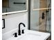 Modern bathroom featuring a sleek sink with black fixtures, a lit mirror and shower with wood look walls at 3421 Fawn Trl, Marietta, GA 30066