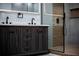 Modern bathroom featuring a stylish dark wood vanity with double sinks and a sleek glass-enclosed shower at 3421 Fawn Trl, Marietta, GA 30066