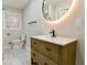 Bathroom features a modern vanity, sleek black faucet, and a stylish, illuminated round mirror at 3421 Fawn Trl, Marietta, GA 30066