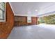 Spacious carport featuring a brick accent wall and ample parking space at 3421 Fawn Trl, Marietta, GA 30066