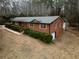 Aerial view of a brick ranch home with a large yard and mature trees at 3421 Fawn Trl, Marietta, GA 30066