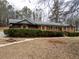 Lovely brick home featuring manicured hedges, front porch and mature trees at 3421 Fawn Trl, Marietta, GA 30066