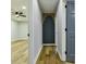 Hallway featuring wood floors and a modern accent wall with gold-tone accents at 3421 Fawn Trl, Marietta, GA 30066