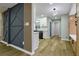 Hallway showcasing decorative wall, hardwood floors, and access to kitchen and other rooms at 3421 Fawn Trl, Marietta, GA 30066