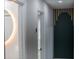 Bright hallway with a view of a modern round mirror and dark accent wall at 3421 Fawn Trl, Marietta, GA 30066